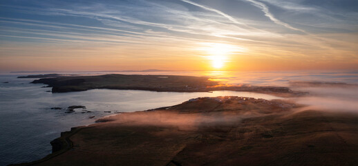 Misty sunrise over the rocky coast of Kilkee, Co. Clare. Ireland