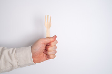 Wooden spoon and fork, a set of kitchen utensils on a white background. Zero waste concept, less...