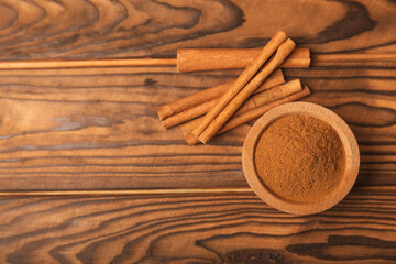 Cinnamon sticks on a textured wooden background. Cinnamon roll. Spicy spice for baking, desserts...