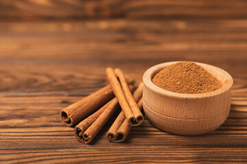 Cinnamon sticks on a textured wooden background. Cinnamon roll. Spicy spice for baking, desserts...