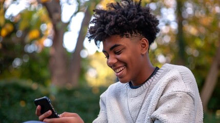 Smiling happy teen using a smartphone to text 