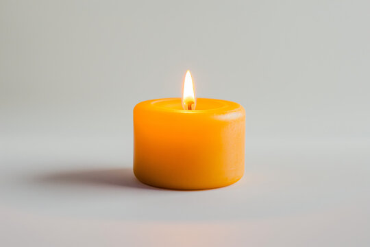 A single lit orange candle against a plain light background, emitting a soft glow.