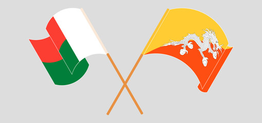 Crossed and waving flags of Madagascar and Bhutan