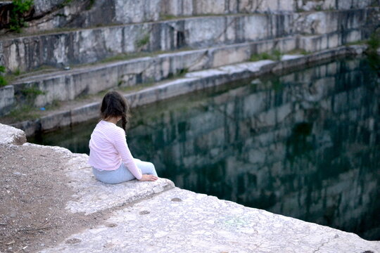 girl sitting on the stone steps