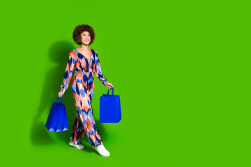 Photo of cute lovely woman wear stylish print clothes hold carry packages look empty space isolated...