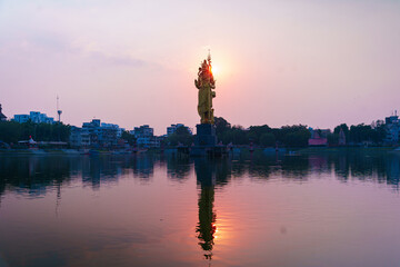 The Statue of Hindu god Lord Shiva in Sursagar Lake is seen at sunset in Vadodara city in the state...