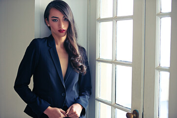 Woman, portrait and fashion suit with luxury style at window door or classy blazer, makeup or...