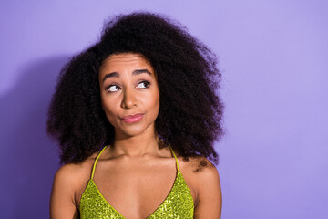 Photo portrait of gorgeous young girl look unsure empty space wear trendy green sequins outfit isolated on purple color background