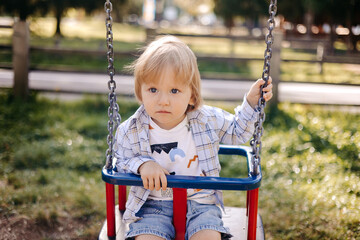 little child swinging on swing