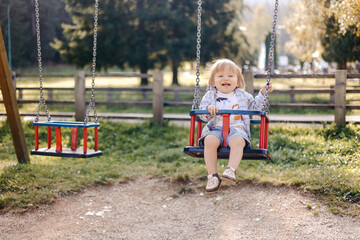 little child swinging on swing