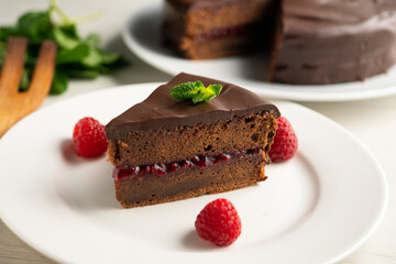 Chocolate Sachertorte with raspberry jam filling.