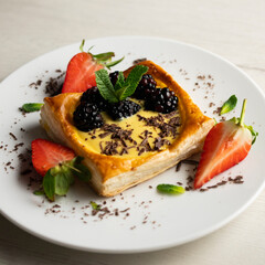Puff pastry dessert with strawberries and blackberries filled with pastry cream.