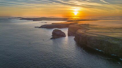 Aerial view - Rocky cliffs in Kilkee at sunrise, County Clare. Ireland.