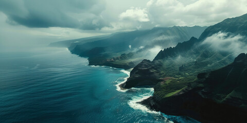 Aerial view of majestic mountains and ocean in Hawaii under a cloudy sky, creating a breathtaking natural landscape