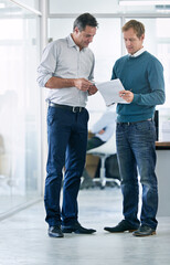 Men, employee and paperwork at office for collaboration, teamwork and information as project...