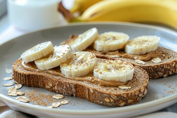 Obraz na płótnie Canvas Plate of whole grain toast with almond butter and banana slices, a healthy and energizing breakfast