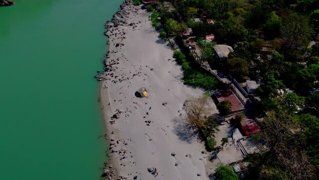drone shot of beautiful river bank view in rishikesh