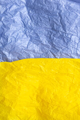 Paper in blue and yellow colors of the flag of Ukraine, UA. Blue and yellow colors. Close up shot, background