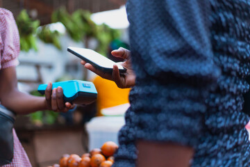 Close-Up NFC Payment Method: Hands Holding POS Terminal and Mobile Phone