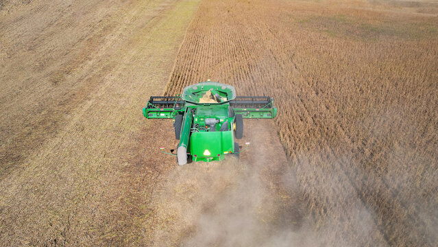 Aerial view of combine harvesters working during the harvest season in a large field of ripe wheat in Argentina.