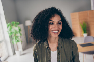 Portrait of pretty young woman toothy smile think imagine wear khaki shirt modern interior house...