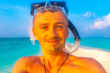 Man with snorkeling equipment fins and snorkeling mask Maldives.