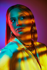 Fusion of classic style with modern jewelry combination, Elegant woman posing against gradient background in neon light. Concept of modern fashion, trendy style, beauty, youth culture
