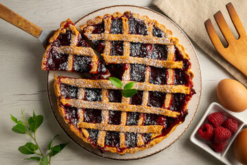 Traditional Italian crostata filled with raspberry jam. Italian dessert with original recipe.