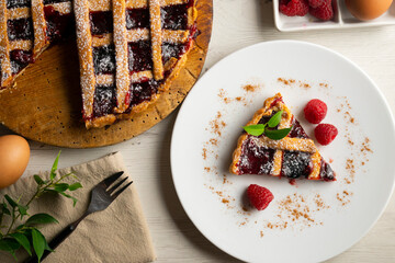 Traditional Italian crostata filled with raspberry jam. Italian dessert with original recipe.