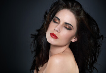 Naklejka premium Calm, wellness and woman in studio for hair beauty, cosmetics and luxury glamour on black background. Makeup, skin and model with shampoo, scalp or glow haircare results, growth and smooth texture