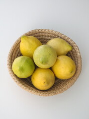 Classic lemon fruits, Citrus limons, on woven basket

