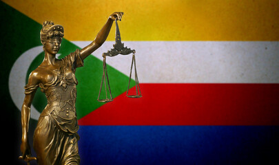 Lady Justice before a flag of the Comoros