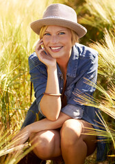 Wheat, farm and portrait of woman with smile for agriculture, sustainability and travel at countryside. Happy, eco friendly and female person with vegetation for adventure, trip and holiday in field