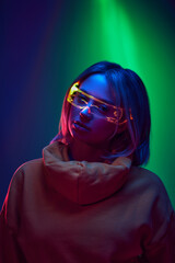 Modern comfort and style. Young girl wearing relaxed hoodie with innovative eyewear against...