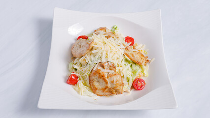 Caesar chicken salad bowl isolated on white
