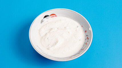 Yogurt bowl isolated on blue