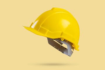 Safety construction helmet on yellow background - 795400483