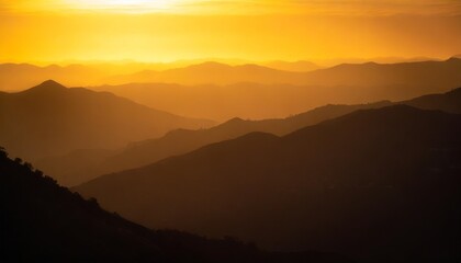 orange and yellow sunset above layers of mountains