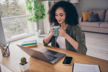 Photo of dreamy cute lady specialist dressed shirt drinking tea working modern device indoors...