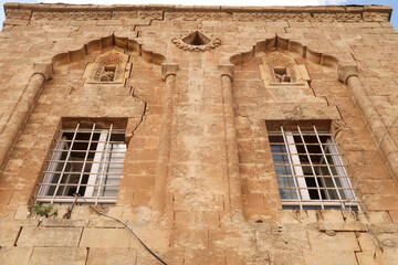 Two windows on the facade of a traditional house in the old town of Mardin, decorated with...