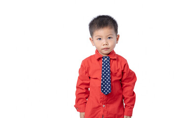 A little boy wearing a suit stands looking at something interesting. Cute expression. Funny, happy. Smart thinking child. Success, motivation concept Go back to school. little businessman.