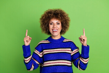 Portrait of cute girl with perming coiffure dressed knit pullover indicating at discount empty...