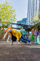 Vertical Screen: Young And Athletic Caucasian B-Boy Breakdancing To Break Beats On The City Street...