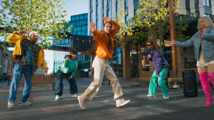 Vibrant Outdoor Scene Capturing A Diverse Group Of Young Adults Joyfully Dancing In An Urban...