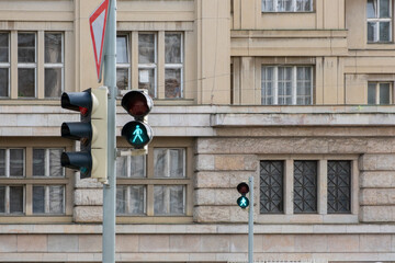 A traffic light with a green signal, indicating the clearance to proceed, historic European city....
