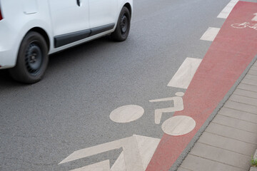 Street markings by paint on asphalt denote a dedicated bike lane in the city, enhancing safety for...