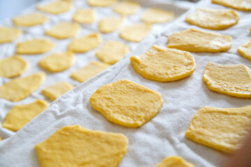 Healthy eating. Raw homemade pasta pastry at the kitchen cloth . Ambient light, High angle view, Copy space. Minimal composition.  