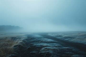 b'Foggy Icelandic Landscape with a Rocky Mountain in the Distance'