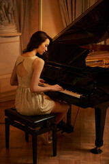 Mansion, play and piano with woman musician, lounge and pianist in a ballroom with luxury instrument. Entertainment, palace and fashion of sound artist with song and playing with glamour and style