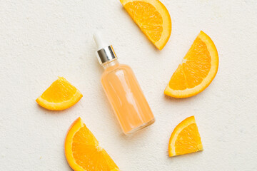 Bottles with orange fruit essential oil on wooden background. alternative medicine top view with...